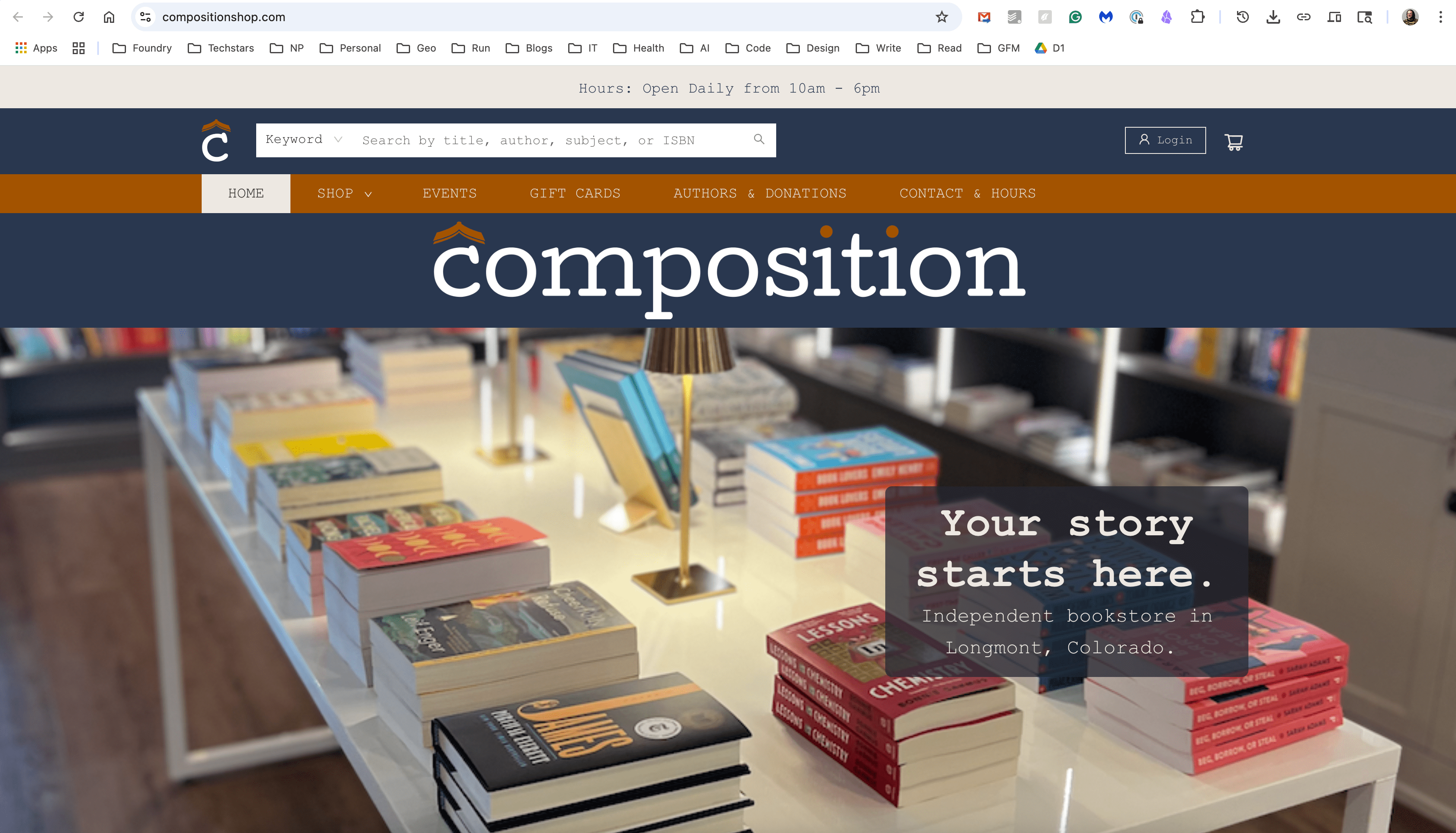 The interior of Composition Shop, an independent bookstore in Longmont, Colorado, showcasing shelves filled with various books and a welcoming atmosphere.