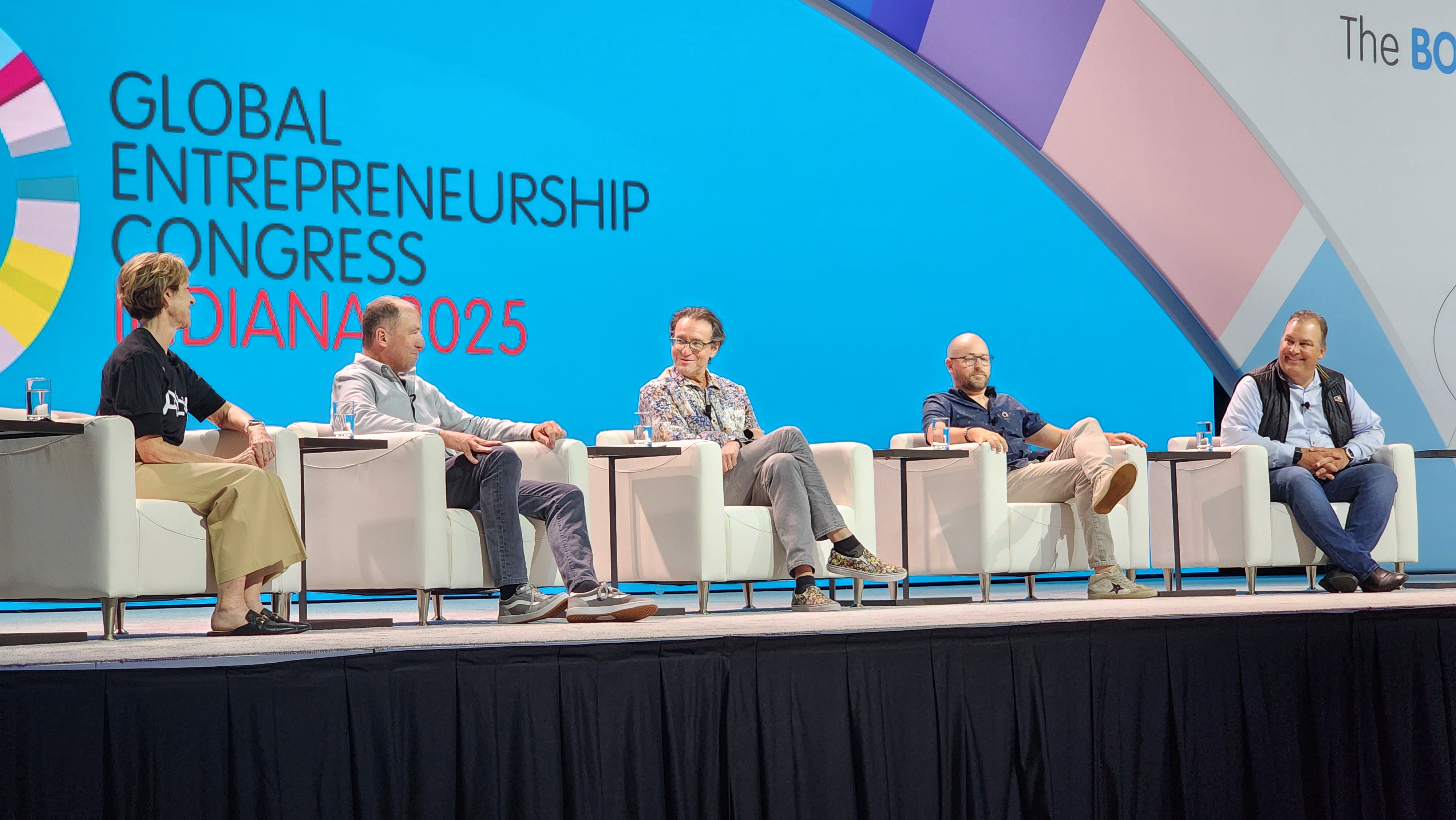 Panel discussion at the Global Entrepreneurship Congress 2025, featuring five speakers seated on stage, with a blue background and event branding.