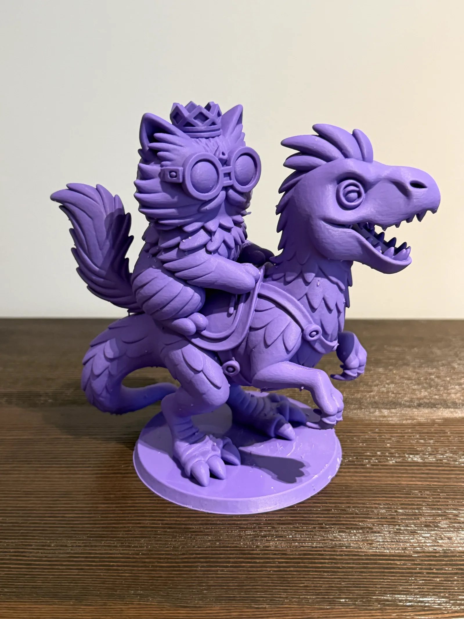 Princess Donut, in her crown and goggles, riding Mongo - a purple 3D print on my shelf